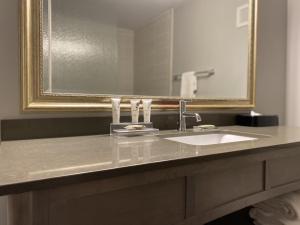 a bathroom sink with a mirror above it at Country Inn & Suites by Radisson, Bemidji, MN in Bemidji