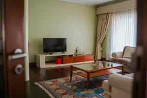 a living room with a couch and a coffee table at Regina Beach - Villa with Private Pool in Viana do Castelo