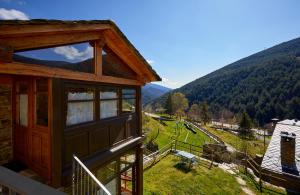 a house with a balcony with a view of a mountain at Cal Mestre in Fornells de la Muntanya