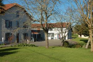 a large white house with trees in front of it at L'Horizon des Landes in Doazit
