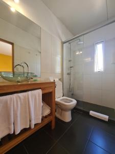a bathroom with a sink and a toilet and a shower at Nova Posada in Colonia del Sacramento +49 photos