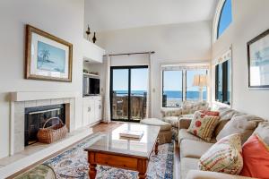 a living room with a couch and a fireplace at Windswept 4309 in Kiawah Island