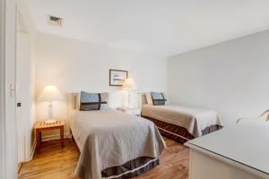 a room with two beds and a table with lamps at Windswept 4309 in Kiawah Island