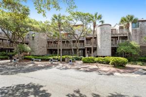 a building with trees and bushes in a parking lot at Windswept 4309 in Kiawah Island