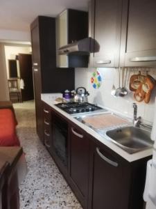 a kitchen with a sink and a stove top oven at Monolocale La Chicca in Castellammare del Golfo