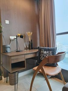 a desk and a chair with a sign on it at Loft Signature Executive Suite Empire City in Petaling Jaya