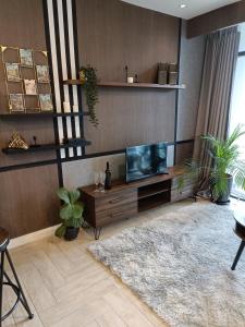 a living room with a tv on a wooden wall at Loft Signature Executive Suite Empire City in Petaling Jaya