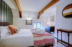 a bedroom with a large bed and a desk at The Old Crab Shop. PERFECT location & sea views. in Cromer