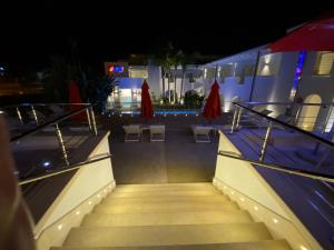 a set of stairs leading to a pool at night at Ganimede Hotel in Sperlonga