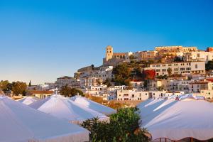 a bunch of white tents in front of a city at The Standard, Ibiza in Ibiza Town