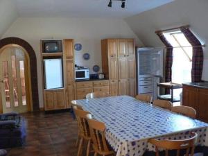 a kitchen with a table with a blue and white table cloth at Tornacraig 8 Person Country House on Royal Deeside in Aboyne