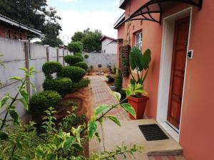 an entrance to a house with a brick walkway at Mashusha Bed & Breakfast in Gaborone