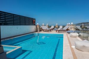 a swimming pool on the roof of a building at Villa Alexandros 3BD with Private Pool in Skouloúfia