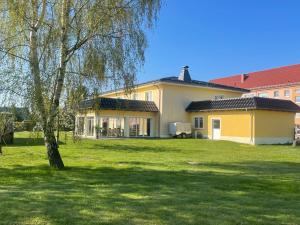 a house with a green lawn in front of it at Die 1A Pension in Welsau