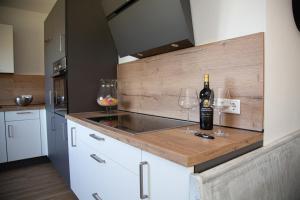 a kitchen with a counter with two glasses of wine at Sauerland Refugium in Medebach