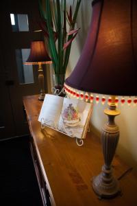une table avec une lampe et une plaque de nourriture sur celle-ci dans l'établissement Hotel Cessnock, à Cessnock
