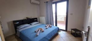 a bedroom with a bed with two towels on it at 'The Seagull' Traditional Cottage in Nea Makri