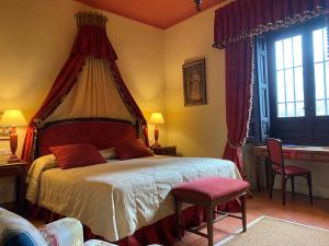 a bedroom with a large bed with a canopy at Caserio de Lobones in Segovia