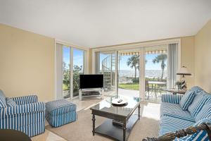un soggiorno con 2 sedie blu e una TV di Sonrisa Unit-3/ Lovely Condo , 2 Bedrooms-2Baths a Clearwater Beach