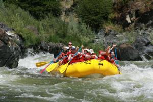 a group of people in a raft on a river at Pensiunea Valea Șușiței, Ciubar, Sauna, ATV, Safarii Jepp Offroad Ghid Turistic, Climbing, Rafting, Paragliding in Târgu Jiu