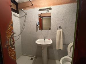 a small bathroom with a sink and a toilet at Hotel Cecil in Marrakech