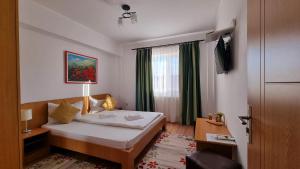 a hotel room with a bed and a window at MOTEL PRISLOP in Haţeg +147 photos
