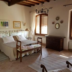 a bedroom with a bed and a table and a window at B&B Casa Fossello in Montabone