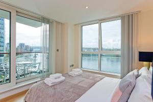 a bedroom with a bed and a large window at River views in London