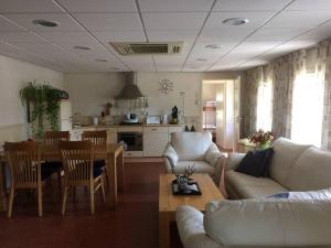 a living room with a couch and a table and a kitchen at Tanja's Guesthouse Kootstertille in Kootstertille