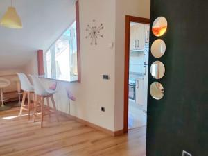 a kitchen and dining room with a table and chairs at Ático Cool Isla de Arousa in Isla de Arosa