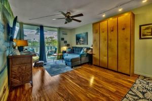 a living room with a couch and a ceiling fan at YOUR HAWAIIAN TROPICAL GARDEN VIEW STUDIO - KONA ISLANDER INN CONDOS condo in Kailua-Kona