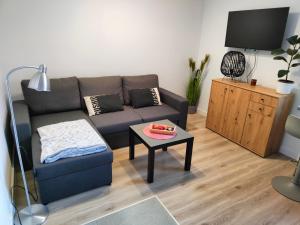 a living room with a couch and a table at Giżycko in Giżycko