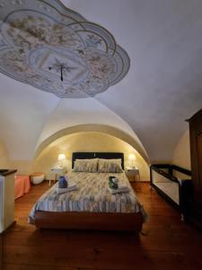 a bedroom with a bed with a painting on the ceiling at My Loft Catania in Catania