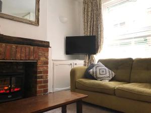 a living room with a couch and a fireplace at Haddock Hideaway by the Sea in Scarborough