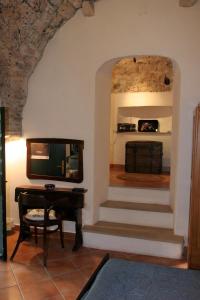 a living room with a tv and a piano at Classique Cavtat Apartment in Cavtat