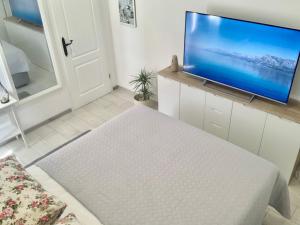 a living room with a large flat screen tv on a wall at Apartment Ana Sea View in Makarska