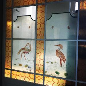 three stained glass windows with birds on them at LaFabriek in Canet d'Aude