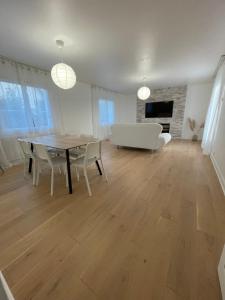 a living room with a table and a couch at Le Cerisier in Meulers