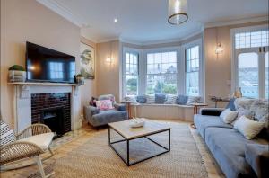 a living room with a couch and a fireplace at Sea View, Beach Road, Cromer in Cromer