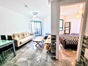 a living room with a couch and a table at Tiberias 521 in Tiberias