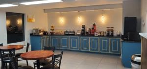 a restaurant with two tables and a blue counter at Excellent Inn & Suites in Natchez