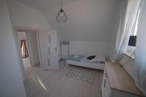 a bedroom with a bed and a room with a door at Baltic Breeze & Spa in Władysławowo