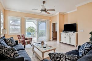 a living room with a couch and a tv at Cinnamon Beach Resort in Palm Coast