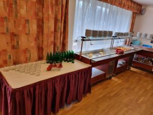 a table with wine glasses and a buffet of food at Wellness hotel Harrachovka in Harrachov +33 photos