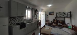 a kitchen with a sink and a stove top oven at Kostas Apartments in Kourouta