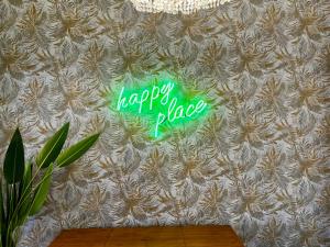 a neon sign that says happy place on a wall at Happy Place! Big, Bright & Central - Ideal for families and groups of friends in Patra