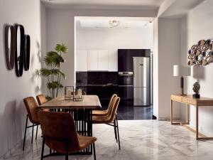 a kitchen and dining room with a table and chairs at Vis di Vardi Luxury Estate in Zakynthos Town