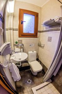 a bathroom with a toilet and a sink at Villa Mariellie in Néa Péramos +49 photos