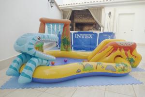 a inflatable dinosaur playset in front of a store at Meravella Casa Rural in Tinajeros