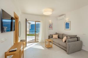 a living room with a couch and a table at Boka Apartment 6 in Herceg-Novi